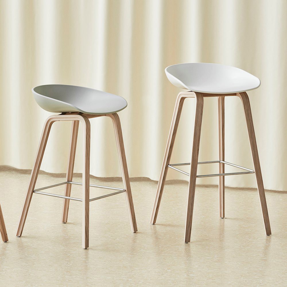 Tabouret pour mange debout ou bar About A Stool de HAY. Coque blanche en polypropylène et pieds en bois massif.